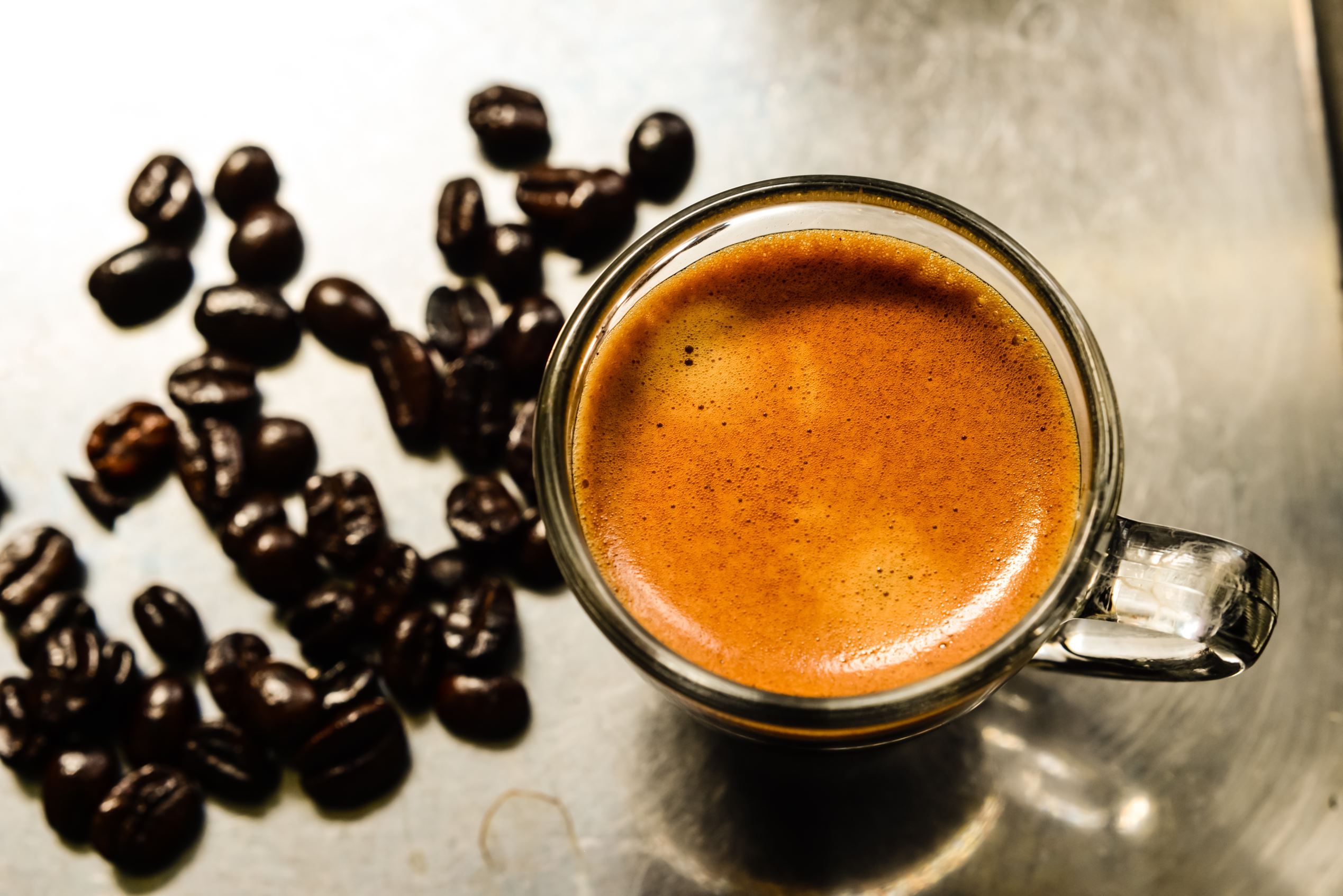 Espresso coffee and beans on the espresso machine.