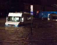 In this Monday, Oct. 29, 2012, file photo, Consolidated Edision trucks are submerged on 14th Street near the ConEd power plant in New York during Superstorm Sandy. Hurricane Joaquin could hit the New York metropolitan area as a tropical storm on Tuesday, potentially following the destructive course of Superstorm Sandy in 2012, weather forecasters said on Thursday.