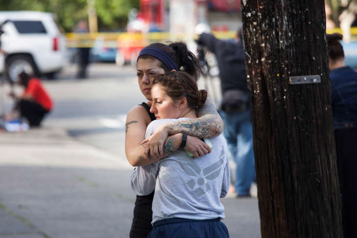 Rana Levy (L) hugs Christine Smith (R) at Seattle Pacific University after a shooting on the campus that left their friends injured in Seattle, Washington June 5, 2014. A man armed with a shotgun opened fire on Thursday at a small Christian college in Seattle, killing one person and wounding three others before he was subdued by a group of students and arrested, Seattle police and hospital officials said.   REUTERS/David Ryder   (UNITED STATES - Tags: CRIME LAW EDUCATION) - RTR3SFQX