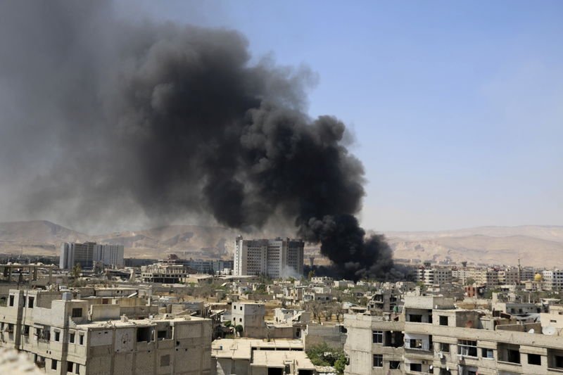 Smoke rises after what activists said were clashes between Al-Rahman corps and forces of Syria's President Assad near Damascus. (Thomson Reuters)