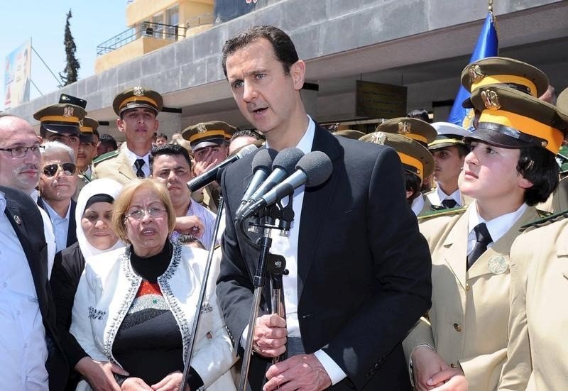 President Bashar Assad addresses his supporters at a school in an undisclosed location during an event to commemorate Syria's Martyrs' Day.