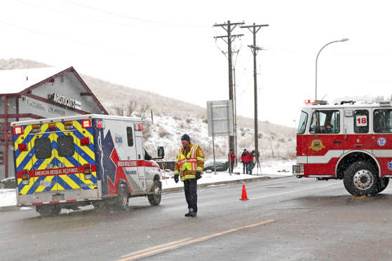 An ambulance proceeds up a secure road leading to a Planned Parenthood center after reports of an active shooter in Colorado Springs, Colorado November 27, 2015.
