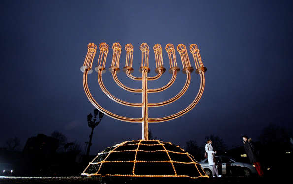 Payment Status: Unpaid  People pass an illuminated menorah in front of the Jewish Museum in Berlin December 18, 2007. The Jewish Museum Berlin is holding a festive Hanukkah Market which will be open till December 31in the new Glass Courtyard. REUTERS/Hannibal Hanschke (GERMANY)...
