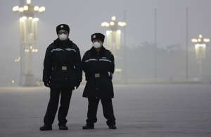 Policemen wear protective masks at the Tiananmen Square on an extremely polluted... - REUTERS/Damir Sagolj Policemen wear protective masks at the Tiananmen Square on an extremely polluted...