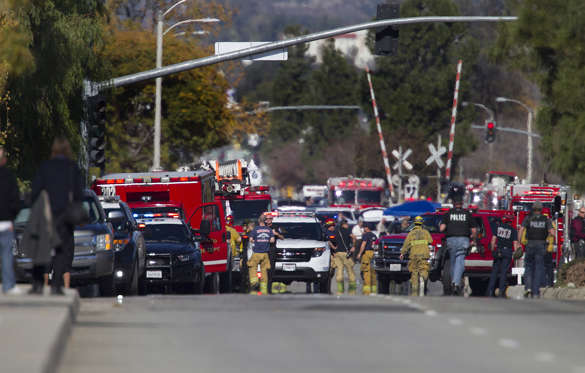 Police and fire personnel secure the scene of a mass shooting at the Inland Regional Center in San Bernardino, Calif., on Wednesday, Dec. 2, 2015.