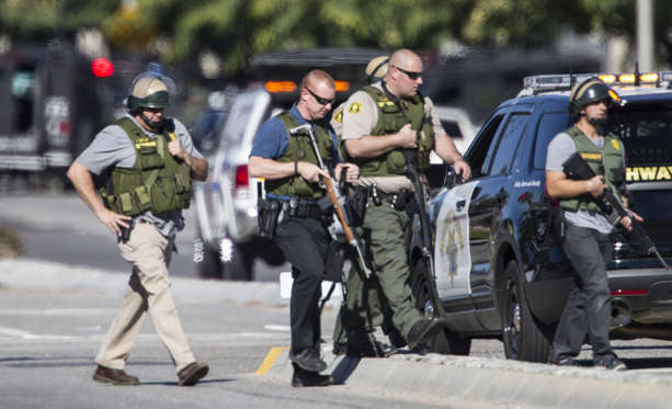 San Bernardino police officers in SWAT gear secure the scene of a mass shooting at the Inland Region... - Gina Ferazzi/Los Angeles Times/TNS San Bernardino police officers in SWAT gear secure the scene of a mass shooting at the Inland Regional Center in San Bernardino, Calif., on Wednesday, Dec. 2, 2015.