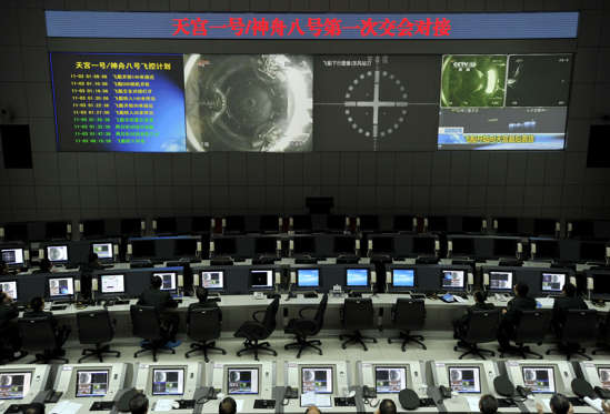 Chinese scientists monitor the docking of the Tiangong-1 space lab module and the Shenzhou VIII spacecraft in space at the Jiuquan Satellite Launch Centre in the northwestern province of Gansu on November 3, 2011. China took a crucial step towards fulfilling its ambition to set up a manned space station by completing its first successful docking high above Earth, state media reported. CHINA OUT AFP PHOTO (Photo credit should read STR/AFP/Getty Images)