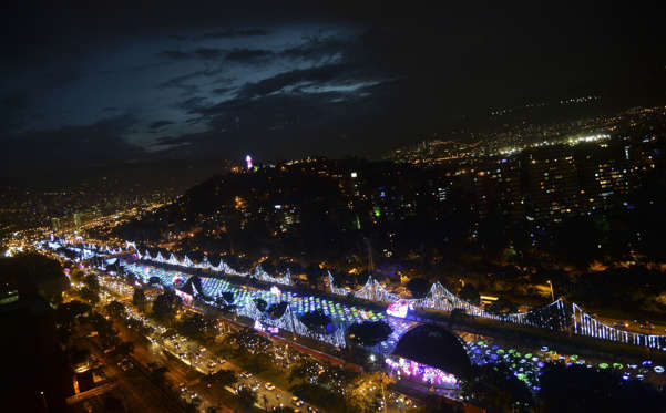 Christmas lights illuminate the Medellin River on December 9, 2014 in Medellin, Antioquia department, Colombia. AFP PHOTO/RAUL ARBOLEDA (Photo credit should read RAUL ARBOLEDA/AFP/Getty Images)