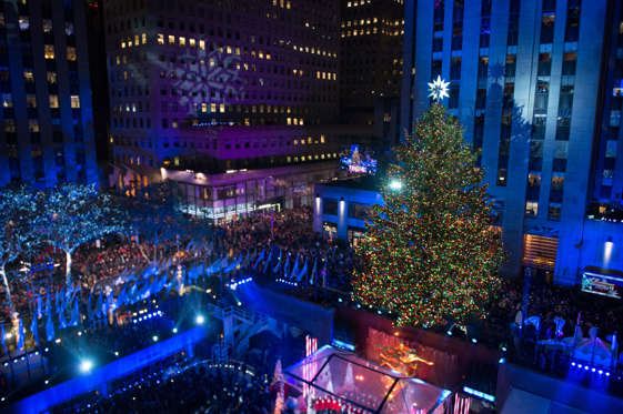 FILE - In this Dec. 2, 2015 file photo, people watch as the Rockefeller Center Christmas tree is lit during the 83rd Annual Rockefeller Center Christmas Tree Lighting Ceremony in New York. The Norway Spruce tree stands at about 78 feet tall and is lit with multi-colored LED lights. (Photo by Brad Barket/Invision/AP, File)
