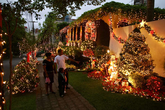 A residence adorned with Christmas decorations made out of recycled materials, shines after dusk in Curitiba, south of Brazil, December 20, 2009. Curitiba, a city populated by people of European ascendancy, is of international renown for its innovative and efficient solutions to deal with pollution and urban waste. AFP PHOTO/ORLANDO KISSNER (Photo credit should read ORLANDO KISSNER/AFP/Getty Images)