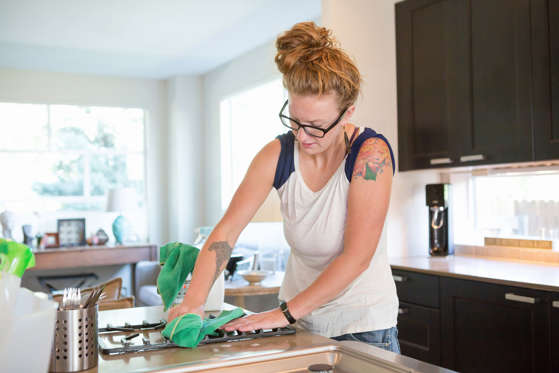 So you cooked up a storm, and your kitchen has seen better days. Clean up your counters and stovetop with three things: baking soda, vinegar, and a little elbow grease. Start by applying white vinegar to the greasy surface. Let it sit for 10 minutes, then scrub it with a damp sponge or cloth that has baking soda sprinkled on it.