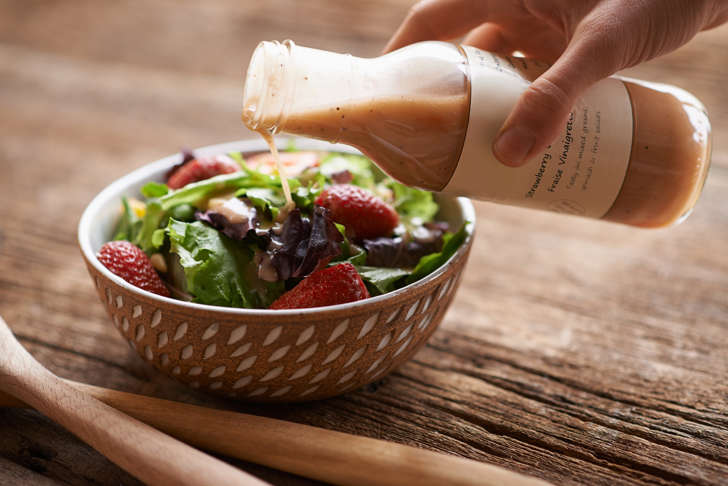 Pouring dressing on salad