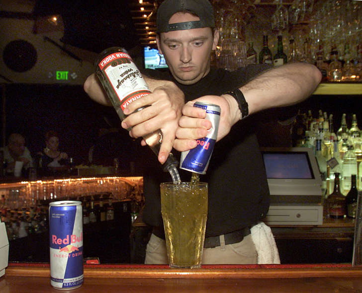 Bartender mixing Red Bull and vodka