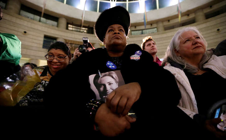 Lennette Williams, of Grosse Pointe Farms, Mich., listens as Democratic presidential candidate, Hillary Clinton speaks during a rally at the Charles H. Wright Museum of African American History, Monday, March 7, 2016, in Detroit, Mich.