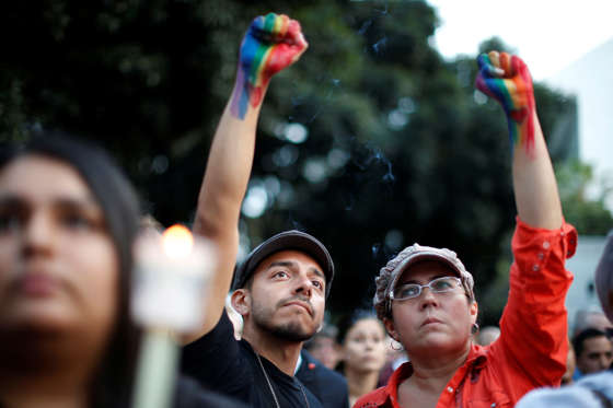 People attend a vigil in memory of victims one day after a mass shooting at the Pulse gay night club in Orlando, in Los Angeles, California, U.S. June 13, 2016.