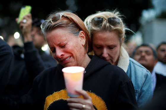 Adele Hoppe-House, 49, (L) and her wife Jennifer Hoppe-House, 52, attend a vigil in memory of victims one day after a mass shooting at the Pulse gay nightclub in Orlando, in Los Angeles, California, U.S. June 13, 2016.