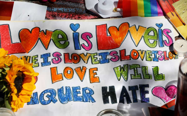 A sign left at a makeshift memorial for victims of the Orlando nightclub shootings lies on the sidewalk in front of the Stonewall Inn, the birthplace of the modern gay rights movement, Wednesday, June 15, 2016, in New York. (AP Photo/Kathy Willens)