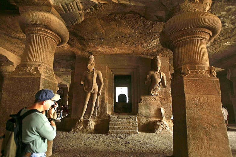 A tourist takes photos at a cave temple on Elephanta island near Mumbai January 21, 2007.