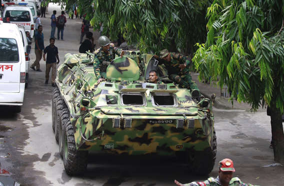 An armored vehicle comes out after an operation against militants who took hostages at a restaurant popular with foreigners in Dhaka, Bangladesh, Saturday, July 2, 2016. Bangladeshi forces stormed the Holey Artisan Bakery in Dhaka's Gulshan area where heavily armed militants held dozens of people hostage Saturday morning, rescuing some captives including foreigners at the end of the 10-hour standoff. [AP Photo)