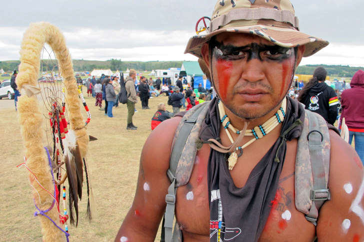 Jon Don Ilone Reed, an Army veteran and member of South Dakota's Cheyenne River Sioux Tribe, poses for a photo at an oil pipeline protest near the Standing Rock Sioux reservation in southern North Dakota, Thursday, Aug. 25, 2016. Reed said he fought in Iraq and is now fighting "fighting for our children and our water."