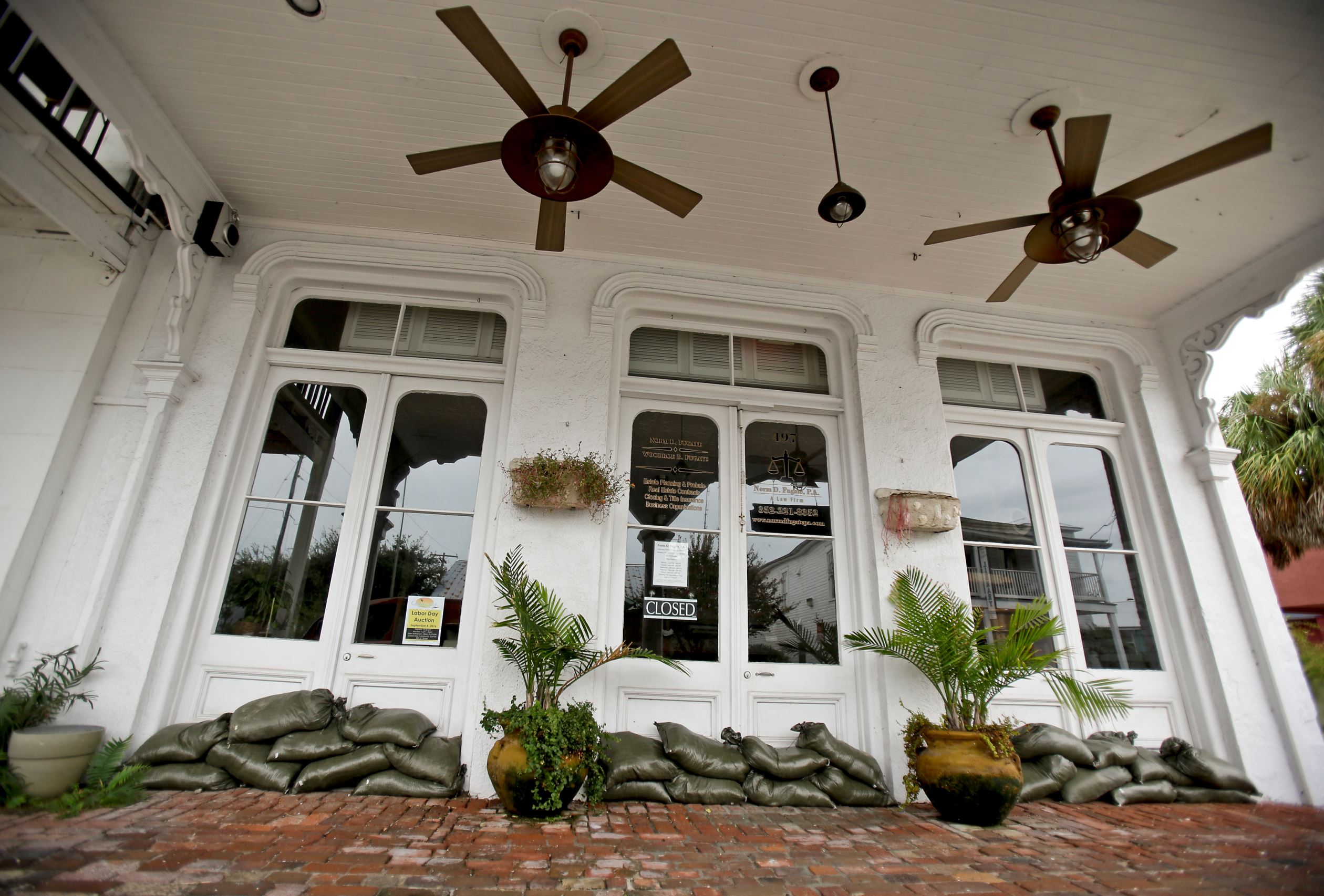 Sandbags line the doors of a business in Cedar Key, Fla. in preparation of Tropical Storm Hermine, Wednesday, Aug. 31, 2016. Forecasters say Hermine could be near hurricane strength by Thursday night as it approaches the Gulf Coast.