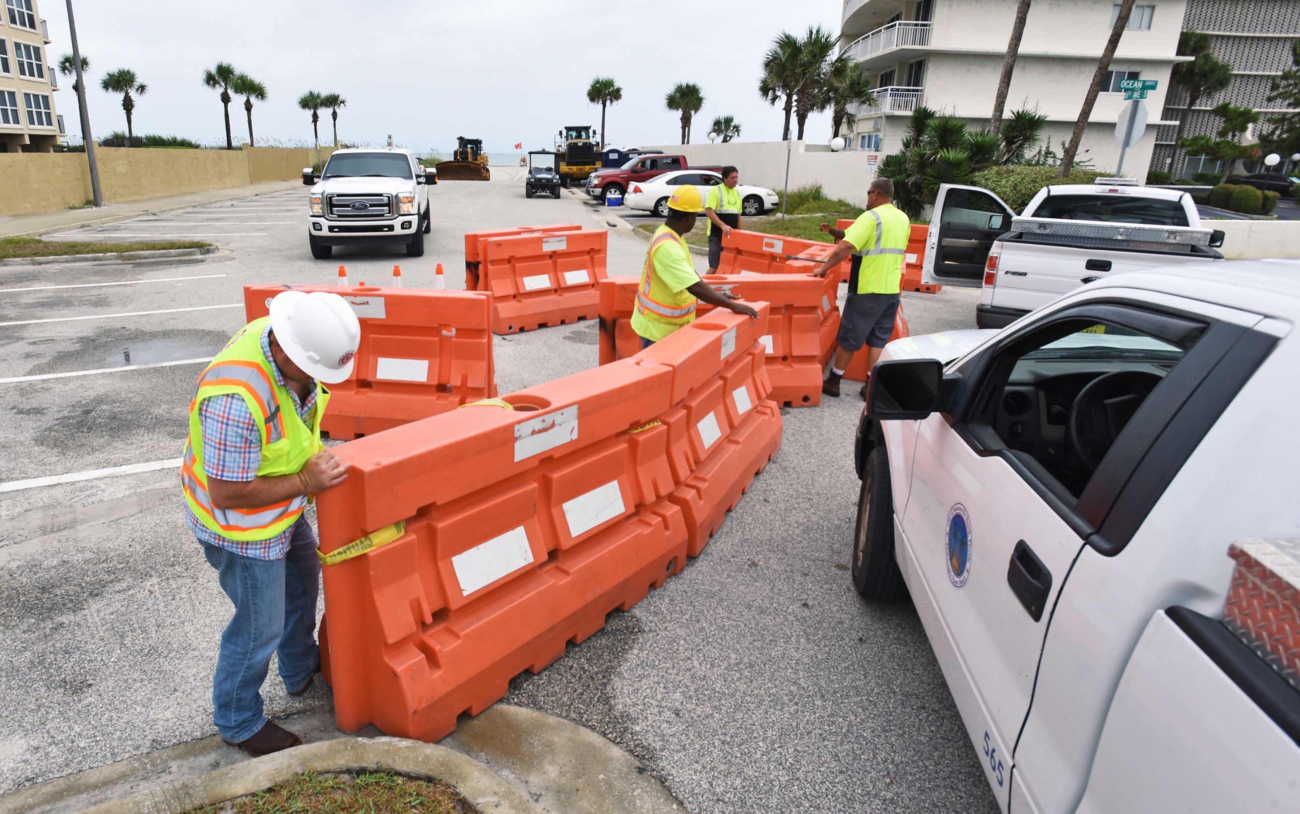 Jacksonville, Fla., Beach Public Works employees put up barricades to close off the 16th. Avenue South parking lot and stage heavy equipment as they prepare for Tropical Storm Hermine, now upgraded to Hurricane status, Thursday, Sept. 1, 2016 ahead of it's expected Gulf Coast landfall Thursday night.