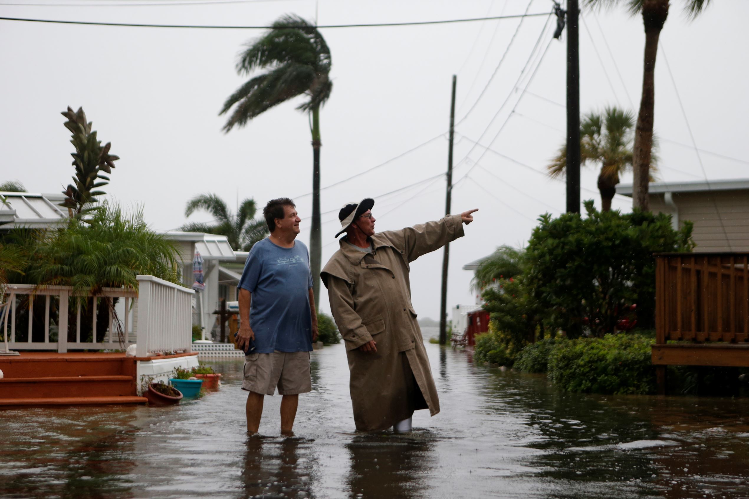 Residents of the Sandpiper Resort survey the rising water coming from the Gulf of Mexico into their neighborhood as winds and storm surge associated with Tropical Storm Hermine impact the area on September 1, 2016 at in Holmes Beach, Florida. Hurricane warnings have been issued for parts of Florida's Gulf Coast as Hermine is expected to make landfall as a Category 1 hurricane.