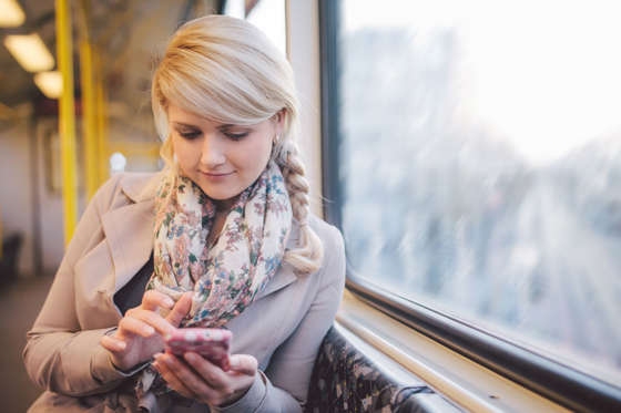 Woman using smart phone in subway.