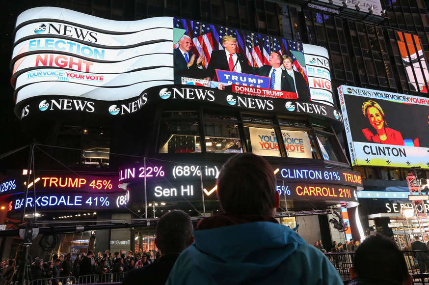 A man watches as Republican president-elect Donald Trump's acceptance speech is broadcast at Times Square Studios after winning the U.S. presidential election in Times Square on November 9, 2016 in New York City. Donald Trump defeated Democratic presidential nominee Hillary Clinton to become the 45th president of the United States.