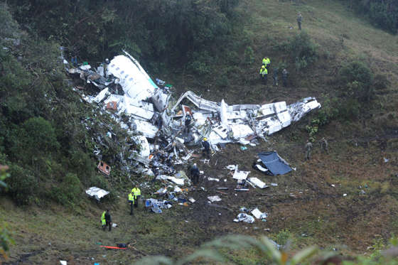 CORRECTS DATE - Police officers and rescue workers search for survivors around the wreckage of a chartered airplane that crashed in La Union, a mountainous area outside Medellin, Colombia, Tuesday, Nov. 29, 2016. The plane was carrying the Brazilian firs