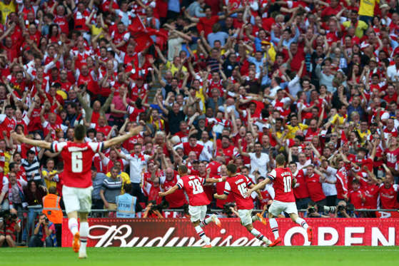 LONDON, ENGLAND - MAY 17:  Aaron Ramsey of Arsenal (16) celebrates with fans and team mates as he scores their third goal during the FA Cup with Budweiser Final match between Arsenal and Hull City at Wembley Stadium on May 17, 2014 in London, England.  (