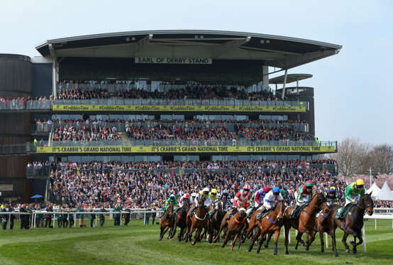 LIVERPOOL, ENGLAND - APRIL 10:  Horses and riders  pass the grandstands during the Alder Hey Children's Charity Handicap Hurdle Race at Aintree Racecourse on April 10, 2015 in Liverpool, England.  (Photo by Alex Livesey/Getty Images)