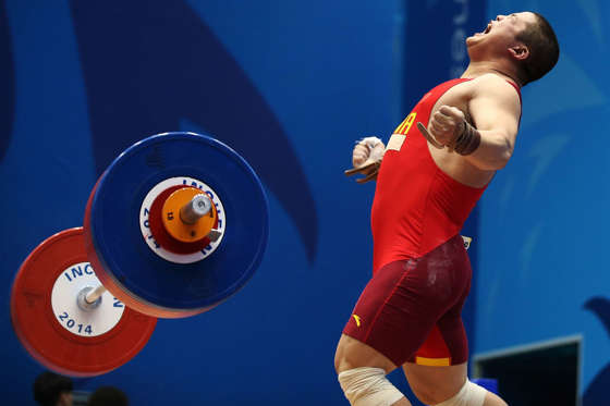 INCHEON, SOUTH KOREA - SEPTEMBER 25:  Hao Lui of China celebrates in the Men's 94kg Weightlifting Final during day six of the 2014 Asian Games at Moonlight Festival Garden Weightlifting Venue on September 25, 2014 in Incheon, South Korea.  (Photo by Bren