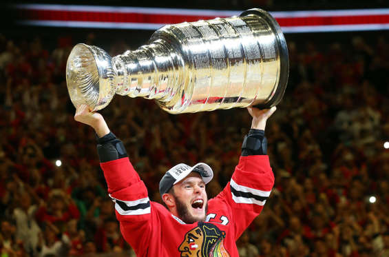 CHICAGO, IL - JUNE 15:  Jonathan Toews #19 of the Chicago Blackhawks celebrates by hoisting the Stanley Cup after defeating the Tampa Bay Lightning  by a score of 2-0 in Game Six to win the 2015 NHL Stanley Cup Final at the United Center  on June 15, 201