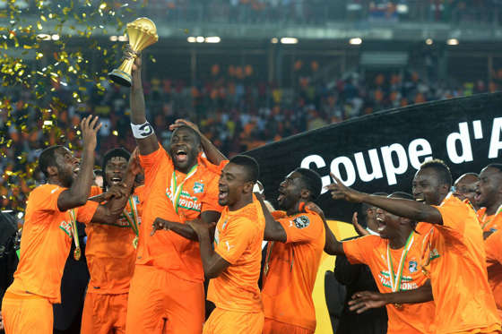 Ivory Coast's midfielder Yaya Toure (3rdL) raises the trophy at the end of the 2015 African Cup of Nations final football match between Ivory Coast and Ghana in Bata on February 8, 2015. Ivory Coast won 9 to 8 on penalties.  AFP PHOTO / KHALED DESOUKI   