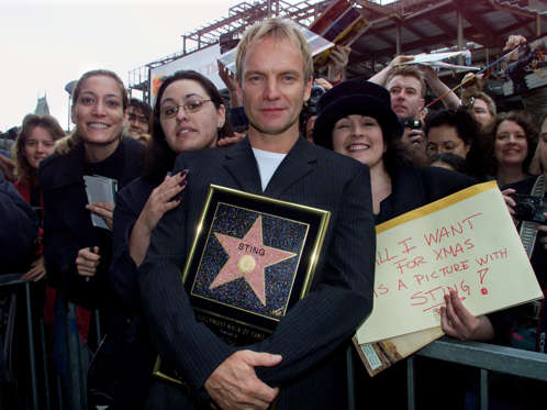 British rock star Sting poses with fans following ceremonies to honor him with a star on the Hollywood Walk of Fame during ceremonies in his honor December 8, 2000 in Hollywood. Sting, who wrote the songs for the new Walt Disney Pictures animated feature "The Emporer's New Groove" has also received 14 Grammy Awards.