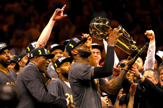 OAKLAND, CA - JUNE 19:  LeBron James #23 of the Cleveland Cavaliers holds the Larry O'Brien Championship Trophy after defeating the Golden State Warriors 93-89 in Game 7 of the 2016 NBA Finals at ORACLE Arena on June 19, 2016 in Oakland, California. NOTE