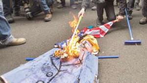 Protesters burn Trump effigy and U.S. flag in Montreal