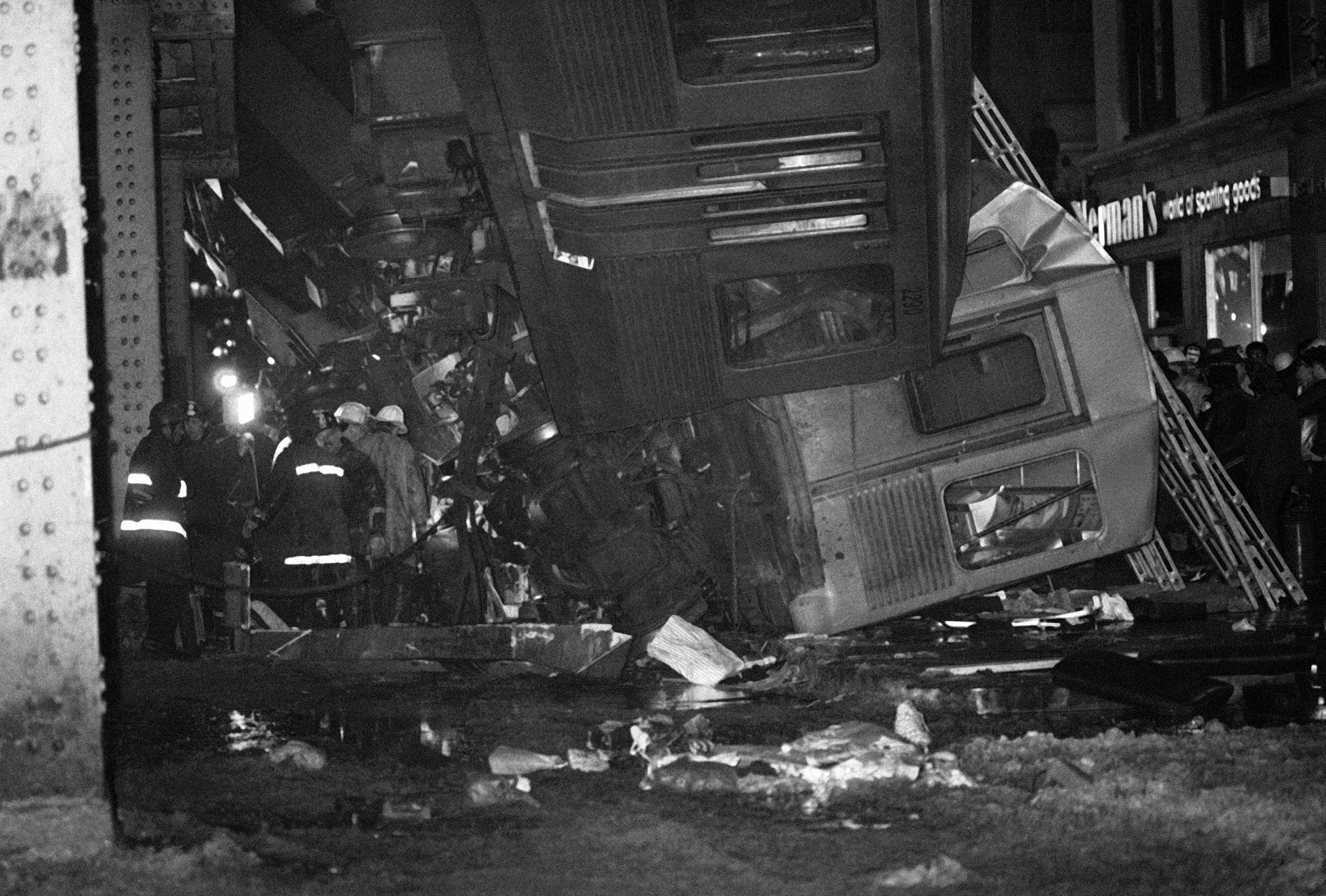 Slide 10 of 15: Rescue workers work to remove victims from the last car to be evacuated following the Chicago Transit Authority elevated train crash in Chicago, Feb. 4, 1977. Three cars fell to the pavement following the crash of two trains. Several fatalities have been reported as well as dozens of injuries.
