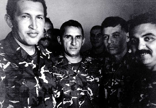 Slide 12 of 15: Venezuelan President Hugo Chavez (L) is shown in a 1992 file photo in jail after being arrested for a coup attempt. He stands next to Francisco Arias (2nd R), who is currently running for president, and former police chief Jesus Urdanetta (back center). According to some military insiders, Chavez, the strong favorite to win the July 30 vote, has upset many within the armed forces with his leftist rhetoric, populist policies and meddling in the military's affairs.