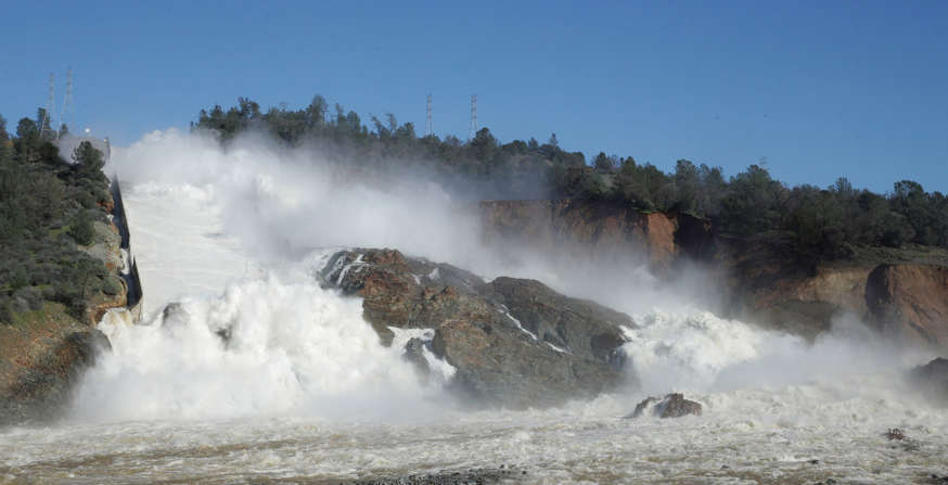 In this Saturday, Feb. 11, 2017, water flows down Oroville Dam's main spillway, near Oroville, Calif. Officials have ordered residents near the Oroville Dam in Northern California to evacuate the area Sunday, Feb. 12, saying a "hazardous situation is developing" after an emergency spillway severely eroded.