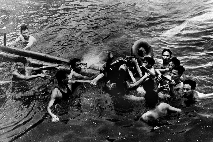 Slide 2 of 17: HANOI, VIET NAM:  A photo taken 26 October 1967 shows US Navy Air force Major John McCain (C) being rescued from Hanoi's Truc Bach lake by several Hanoi residents after his Navy warplane was downed by Northern Vietnamese army during the Vietnam War. One of his rescuers said 24 February 2000, McCain was well treated after being pulled from the lake by villagers. McCain said that upon capture he was beaten by an angry mob and bayoneted in the groin.