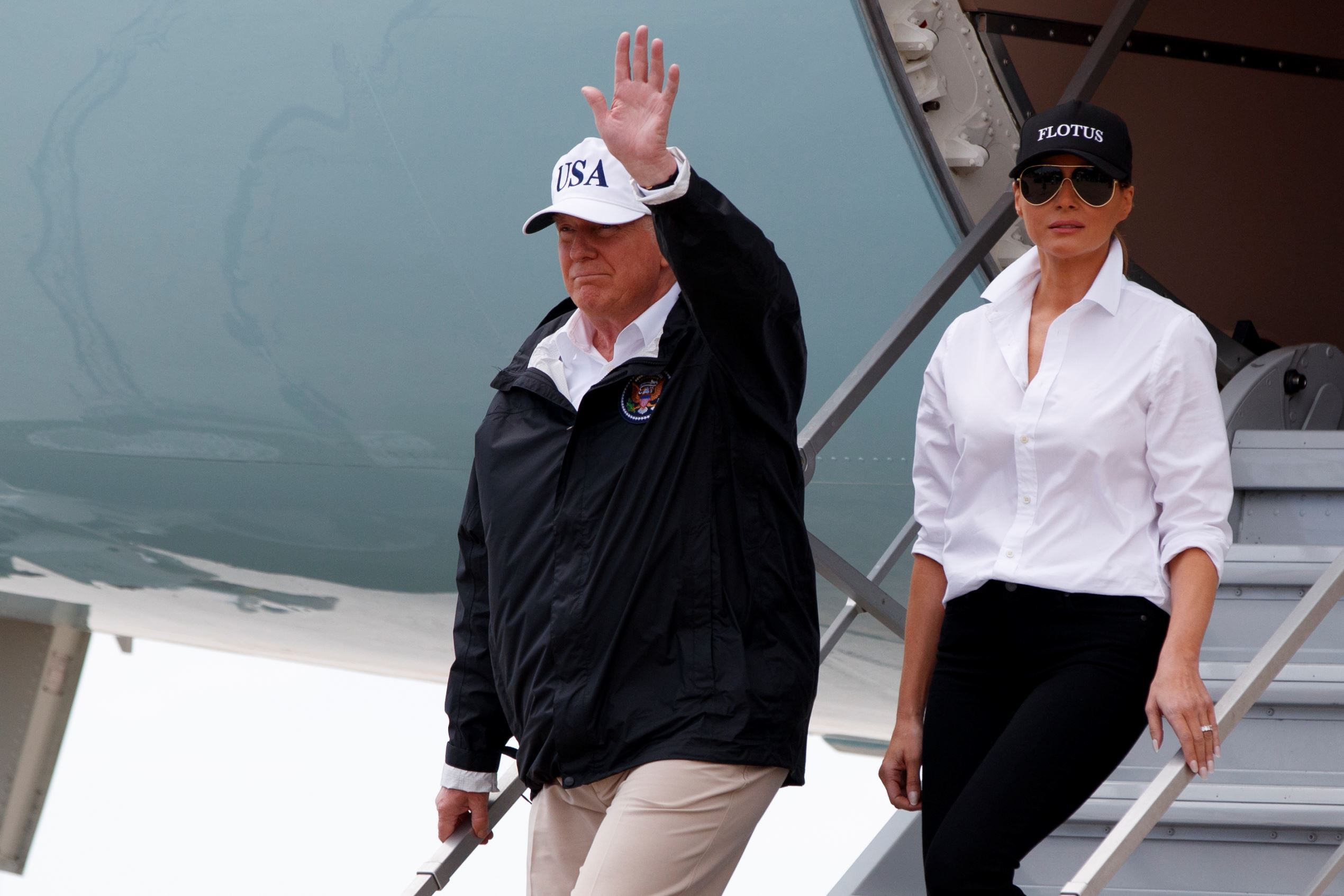 President Donald Trump, accompanied by first lady Melania Trump, waves as they arrive on Air Force One at Corpus Christi International Airport in Corpus Christi, Texas, Tuesday, Aug. 29, 2017, for briefings on Hurricane Harvey relief efforts.