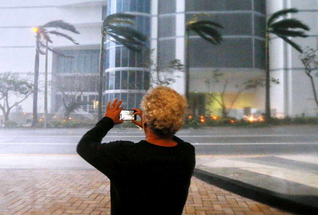 Slide 6 of 74: Mandatory Credit: Photo by ERIK S. LESSER/EPA-EFE/REX/Shutterstock (9049175e) A person photographs the fierce winds with his mobile phone as the full effects of Hurricane Irma strike in Miami, Florida, USA, 10 September 2017. Many areas are under mandatory evacuation orders as Irma approaches Florida. The National Hurricane Center has rated Irma as a Category 4 storm as the eye crosses the lower Florida Keys. Hurricane Irma in Miami, USA - 10 Sep 2017