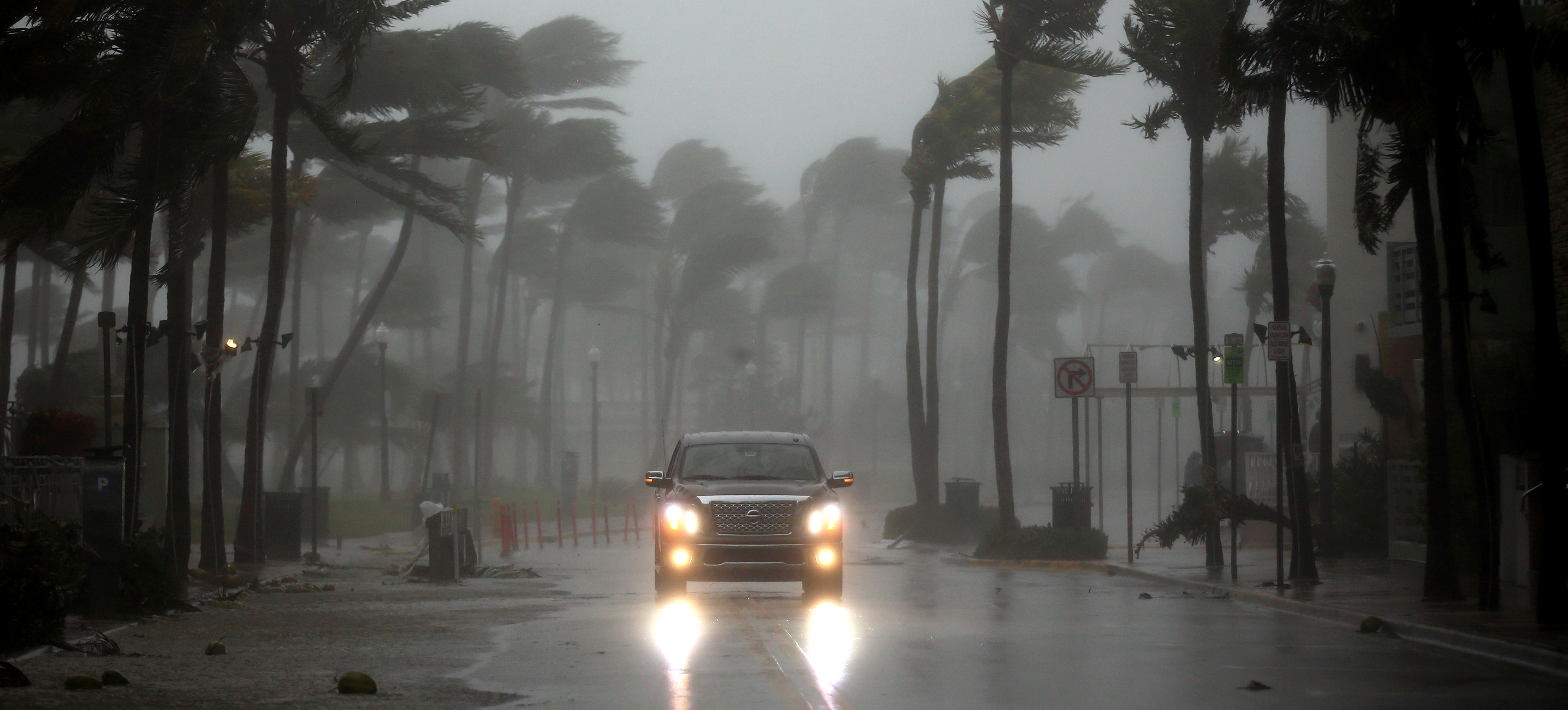 A vehicle drives along Ocean Drive in South Beach as Hurricane Irma arrives at south Florida, in Miami Beach, Florida, U.S., September 10, 2017.