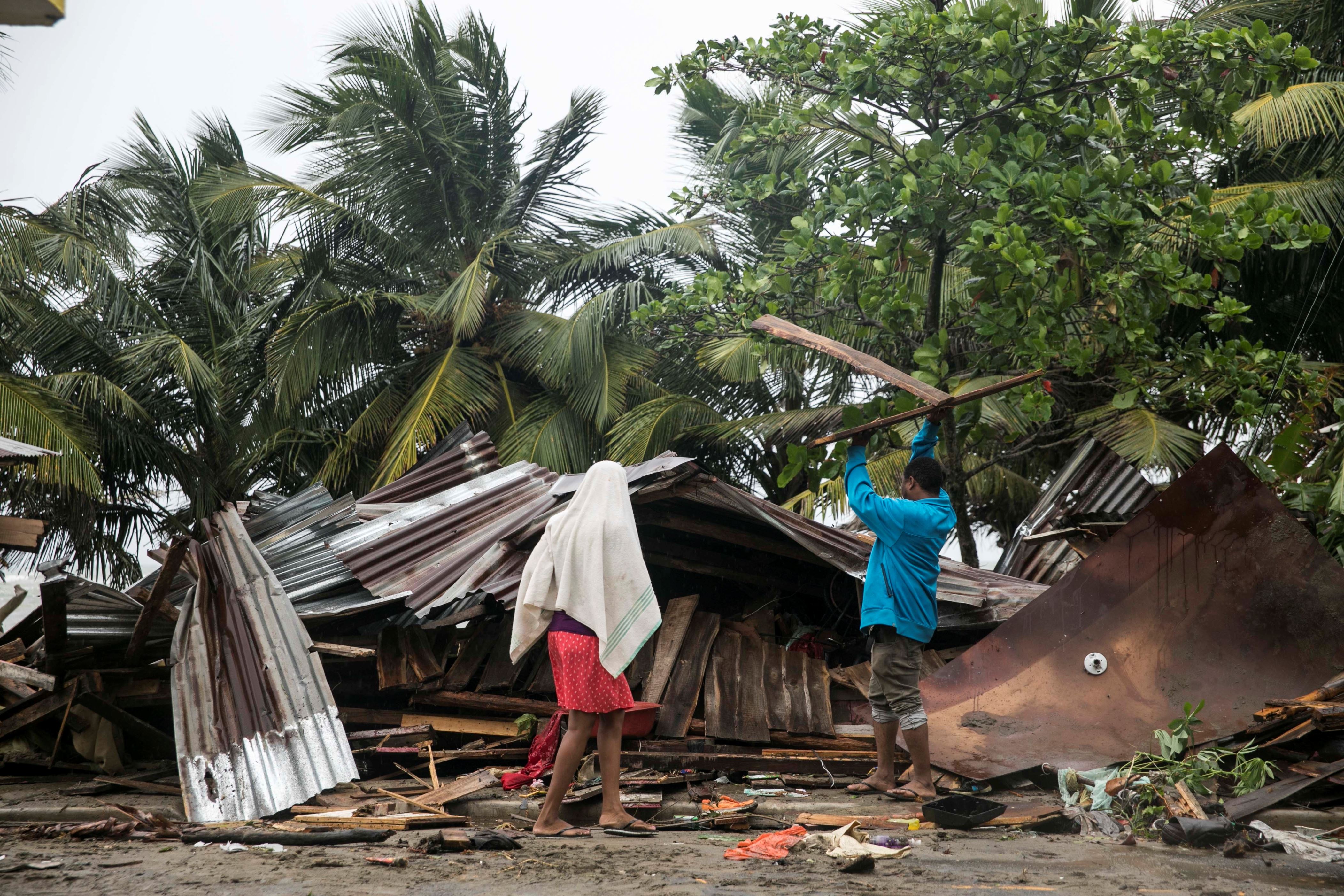 A man begins the task of rebuilding his home after it was damaged by Hurricane Irma in Nagua, Dominican Republic, Thursday, Sept. 7, 2017. Irma cut a path of devastation across the northern Caribbean, leaving thousands homeless after destroying buildings and uprooting trees. Irma flooded parts of the Dominican Republic when it roared by Thursday, just off the northern coast of the island it shares with Haiti. (AP Photo/Tatiana Fernandez)