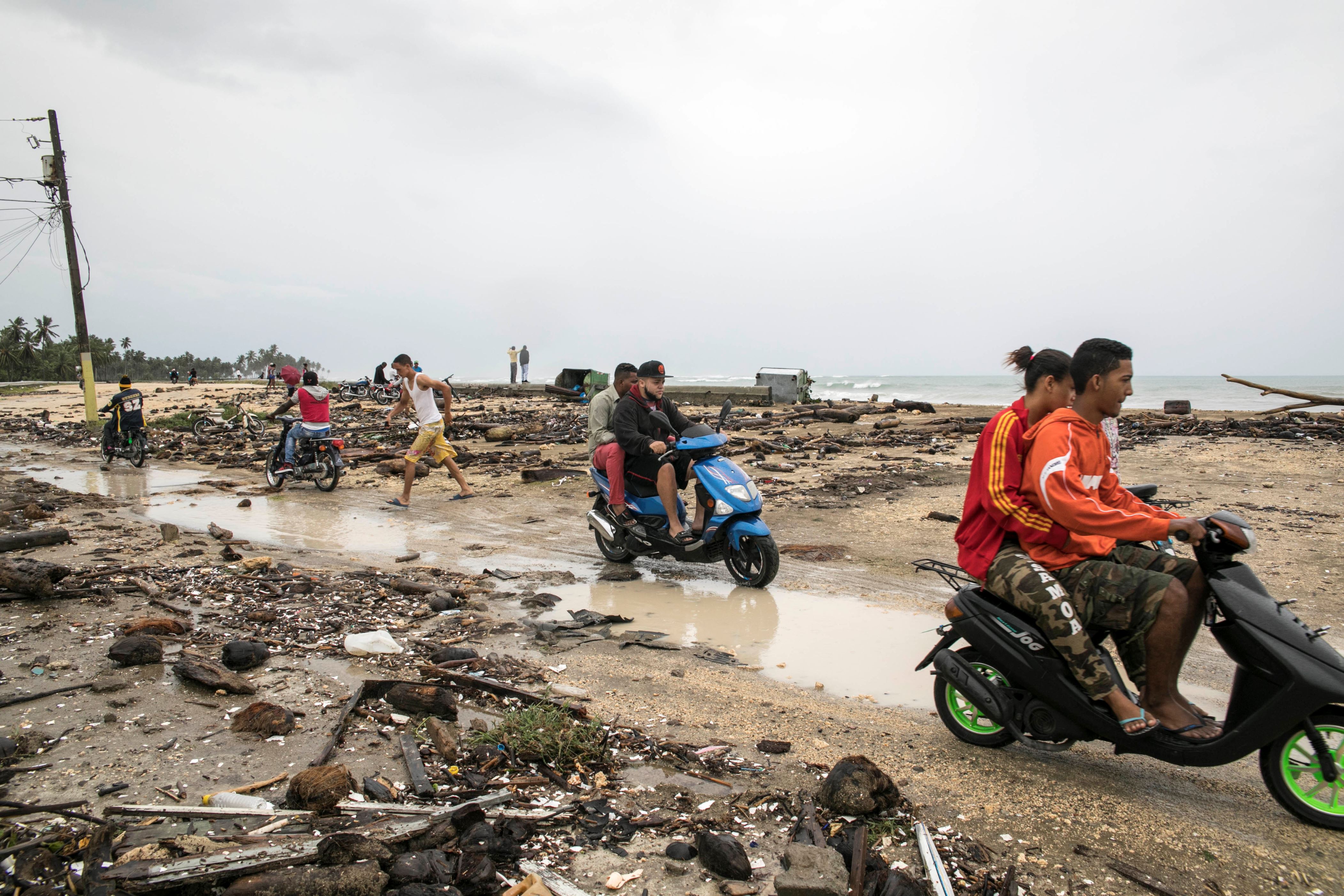 Residents come out to survey the damage caused by Hurricane Irma in Nagua, Dominican Republic, Thursday, Sept. 7, 2017. Irma cut a path of devastation across the northern Caribbean, leaving thousands homeless after destroying buildings and uprooting trees. Irma flooded parts of the Dominican Republic when it roared by Thursday, just off the northern coast of the island it shares with Haiti. (AP Photo/Tatiana Fernandez)