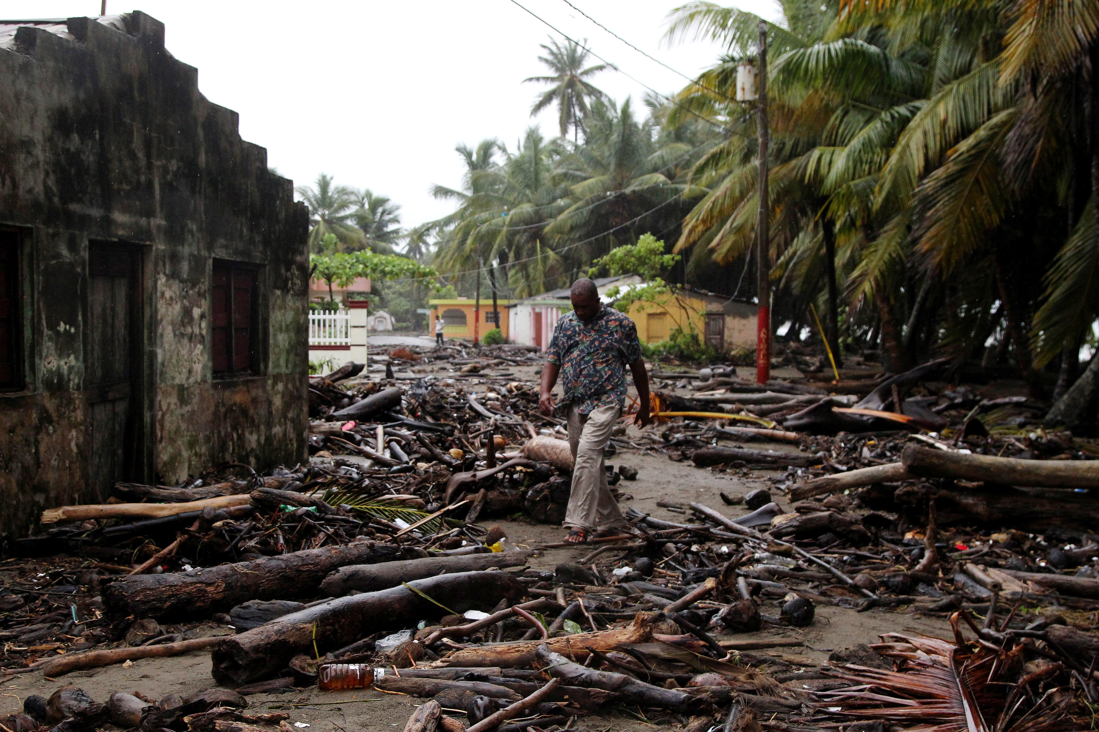 A man walks among debris as Hurricane Irma moves off the northern coast of the Dominican Republic, in Nagua, Dominican Republic, September 7, 2017.