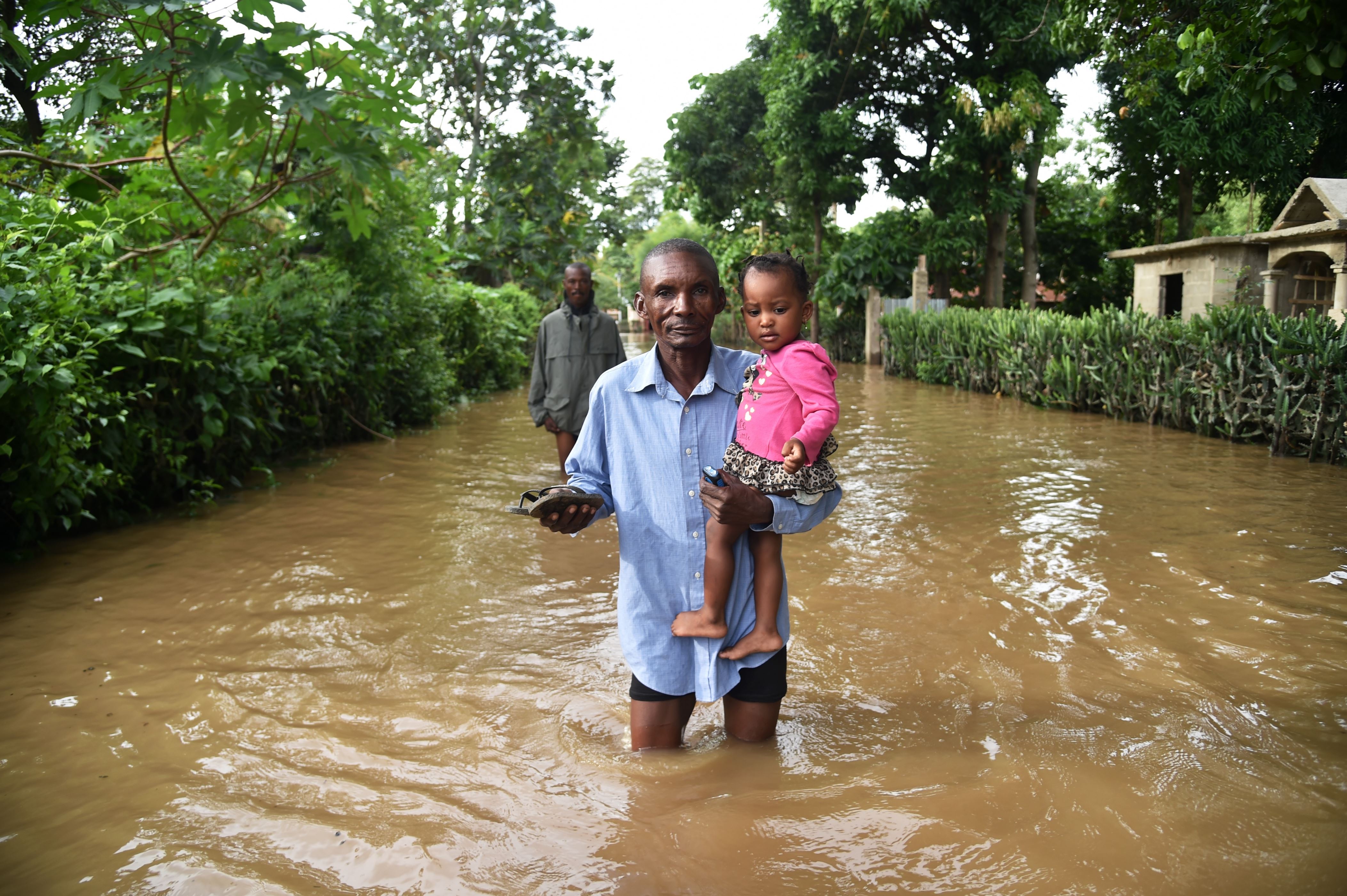 A man walks in street that was flooded in Malfeti, in the city of Fort Liberte, in the city of Fort Liverte, in the north east of Haiti, on September 8, 2017, during the passage of Hurricane Irma. Irma has been downgraded to a Category Four hurricane but is still extremely dangerous, the National Hurricane Center said. / AFP PHOTO / HECTOR RETAMAL (Photo credit should read HECTOR RETAMAL/AFP/Getty Images)