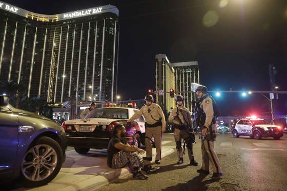 Slide 3 of 16: Police officers stand at the scene of a shooting near the Mandalay Bay resort and casino on the Las Vegas Strip, Sunday, Oct. 1, 2017, in Las Vegas. Multiple victims were being transported to hospitals after a shooting late Sunday at a music festival on the Las Vegas Strip.